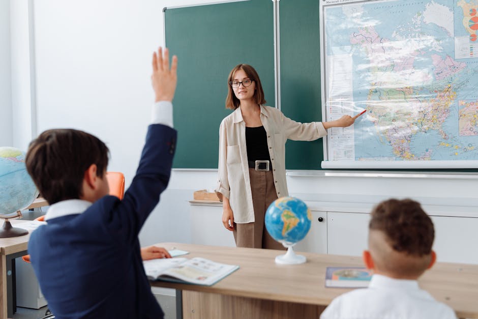 A teacher explaining geography with a map to students in a classroom setting.